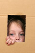 Image : young girl looking from brown carton box