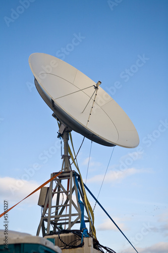 Photo: broadbrand satelite dish on blue sky background broadbrand satelite dish on blue sky background