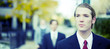 three business men standing and looking in same direction
