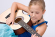 girl learning to play guitar
