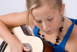 girl learning to play guitar