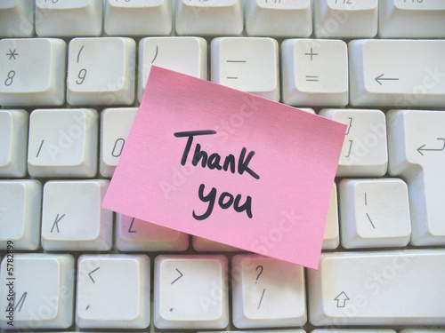 Photo: thank you message post-it note on a computer keyboard thank you message post-it note on a computer keyboard