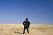 Businessman looking to the future in a field
