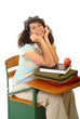 Excited young student at a desk with books and an apple