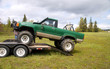4x4 being unloaded from a trailer.