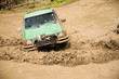 4x4 with a snorkel plowing through a mud hole.