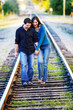 Couple walking in RR track. Laughing