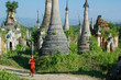 young monk walkng between stupas young monk walkng between stupas