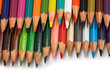 Assortment of coloured pencils with shadow on white background