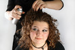 A girl getting her hair done.