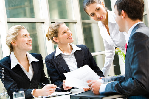 Photo: Team of business people discussing an important question Team of business people discussing an important question