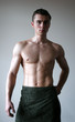 Wat sexy muscular man wrapping a towel after shower