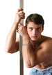 Muscular sexy man leaning on a metal pole isolated on white