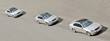 three similar identical twins cars drive in a line