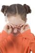 Young girl covering her face