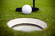 A golfer attempts to make a very short putt