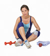 Young woman resting on a floor during a fitness break. Young woman resting on a floor during a fitness break.