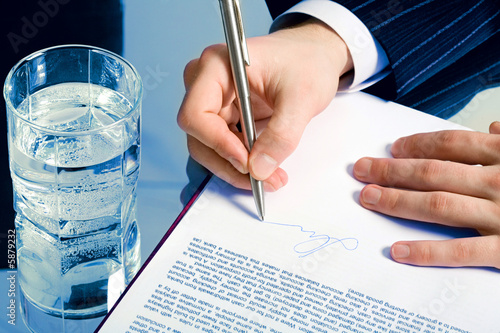 A businessman’s hands signing a contract 