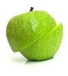 The wet green apple is cut on two parts. Isolation on white