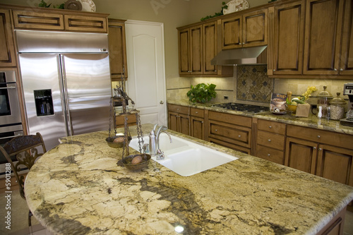 Photo: Luxury home kitchen with a granite top island. Luxury home kitchen with a granite top island.