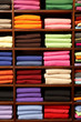 Piles of multicolored knitted woolen clothing