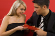 Handsome man is giving beautiful woman a gift. 