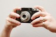 hands holding an old camera