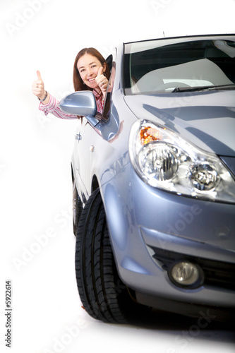 happy woman with her new car - thumbs up 