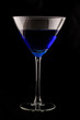 Photo: martini glass filled with blue drink shot on black martini glass filled with blue drink shot on black