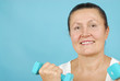 Attractive older woman exercising with free weights.