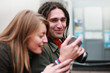 Young couple looking at digital photos