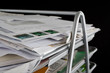 Messy in-basket with papers Messy in-basket with papers