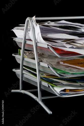 Photo: Messy in-basket with papers Messy in-basket with papers