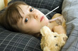 A young girl lying in bed with an illness