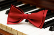 Red bow tie on the piano keys