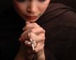 a woman is praying to god with hope