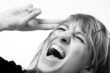Screaming woman shielding her eyes from the light