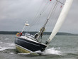 Yacht racing in a windy dark winter day.