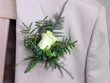 Groom's wedding suit with boutonniere of rose and leaves