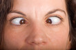 closeup of brunette woman face seriously squinting