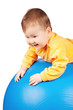 Baby on big ball isolated on white