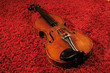 Violin on red carpet