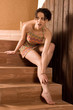 Shot a young pretty brunette woman sitting on stairs Shot a young pretty brunette woman sitting on stairs
