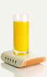 Glass of juice standing on computer modem