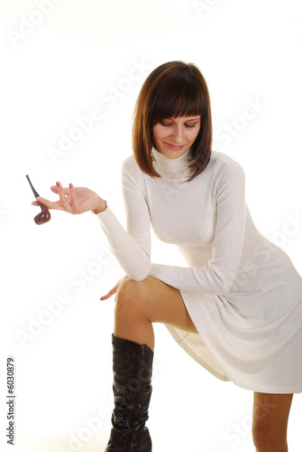 Photo: Pretty young woman with pipe dressed in white dress Pretty young woman with pipe dressed in white dress