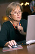 Mature woman using a laptop computer, portrait Mature woman using a laptop computer, portrait