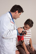 A doctor takes a patients blood pressure