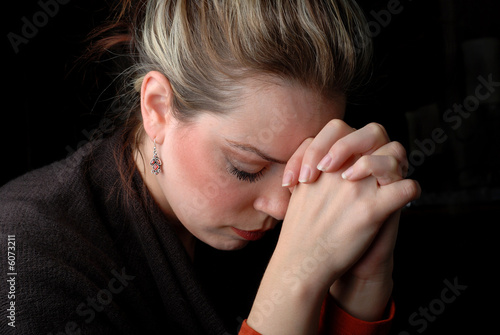 a woman is praying to god with hope