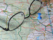 Glasses on a pin-pointed map Glasses on a pin-pointed map