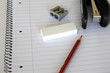 pencil,eracer and stapler on a notepad pencil,eracer and stapler on a notepad